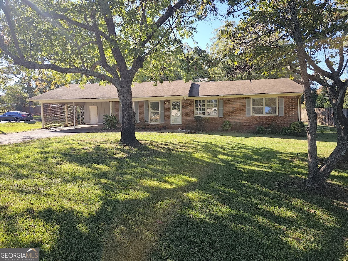 a front view of a house with yard and green space