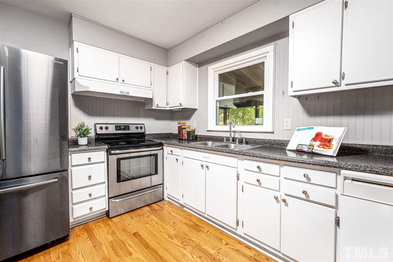 4608 Revere Road Durham, NC 27713 - Photo 7 of 29 a kitchen with cabinets appliances and a window