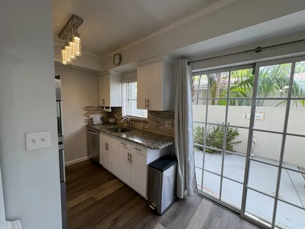 a kitchen with stainless steel appliances granite countertop a stove and a refrigerator