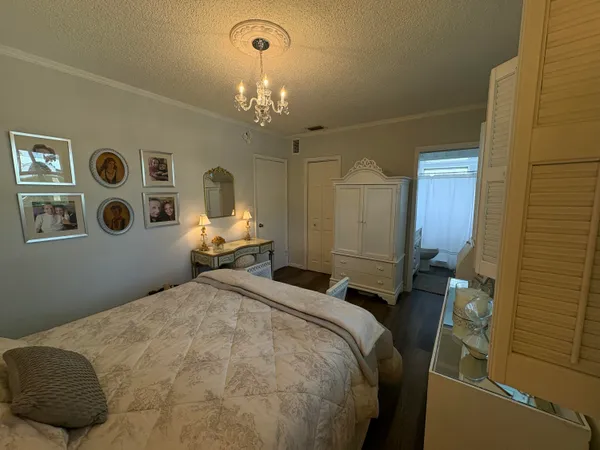 a bedroom with a bed and a chandelier