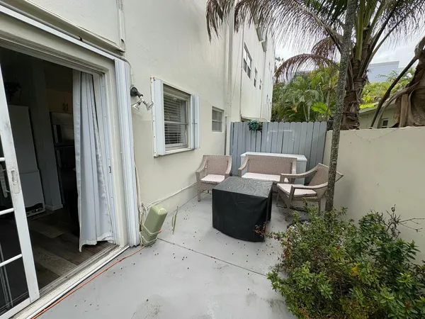 a table and chair sitting in front of a door