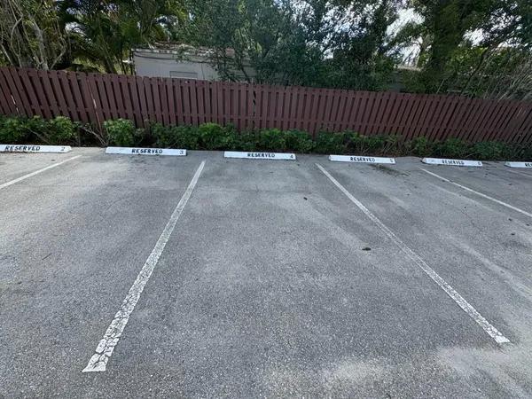 a view of a street with wooden fence