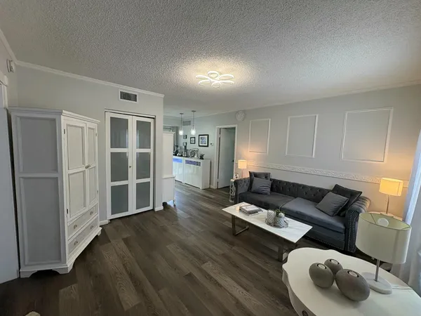 a living room with furniture and wooden floor