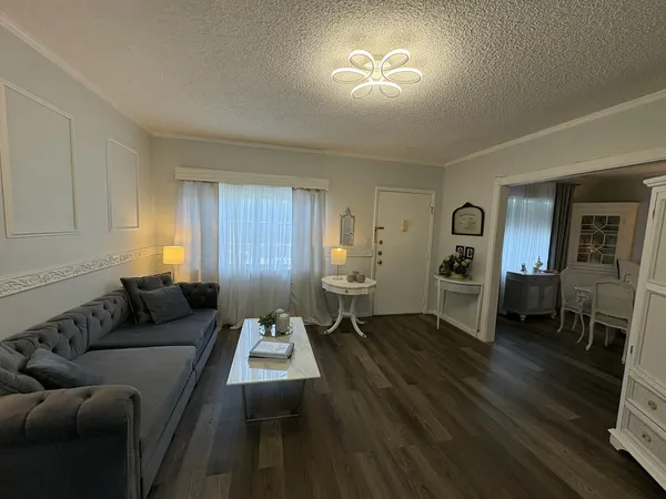 a living room with furniture and a chandelier