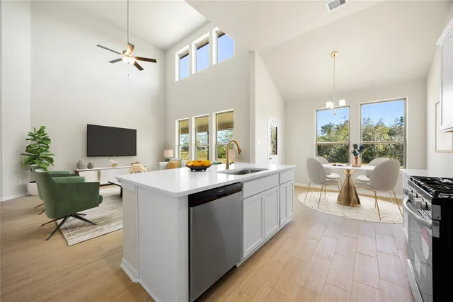 a kitchen with a sink and chairs