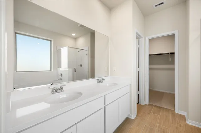 a bathroom with a double vanity sink mirror and
