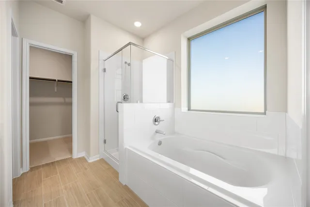 a bathroom with a bathtub and a shower