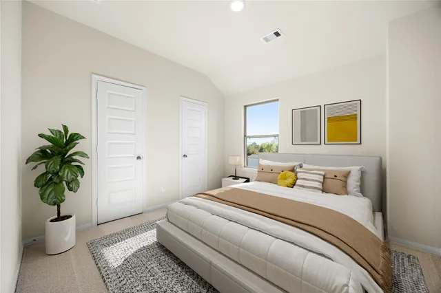 a bedroom with a potted plant and a window