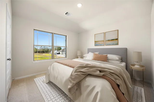 a bedroom with a bed and painting on the wall