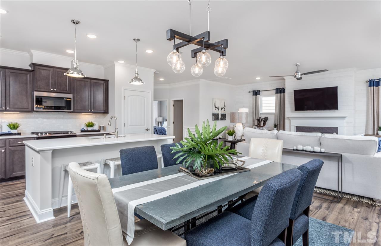 1720 Highpoint Street, Unit HV 264 Wake Forest, NC 27587 - Photo 12 of 20 a living room with furniture a flat screen tv and kitchen view