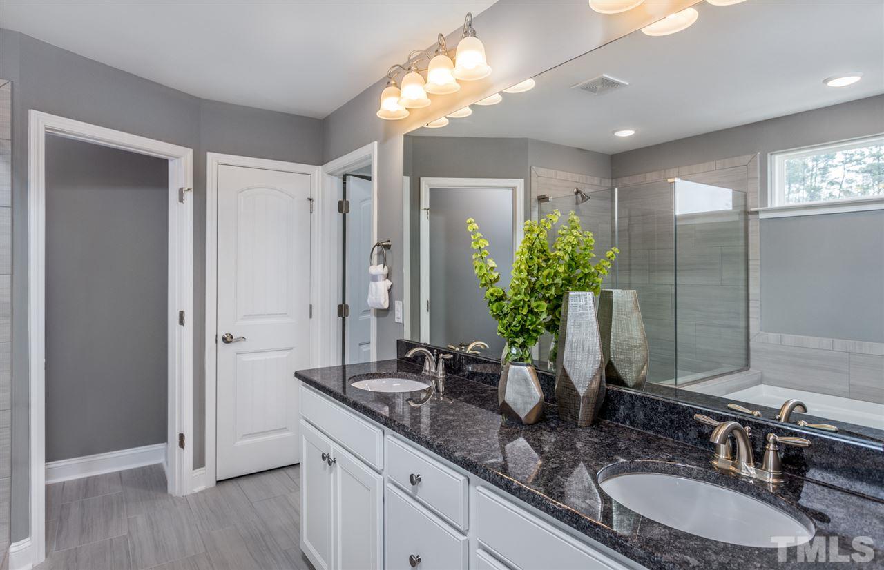 1720 Highpoint Street, Unit HV 264 Wake Forest, NC 27587 - Photo 19 of 20 a bathroom with a double vanity sink and a mirror