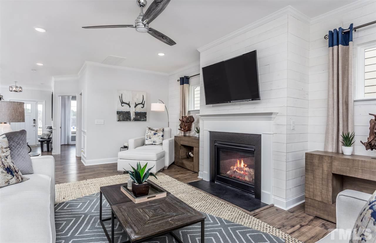 1720 Highpoint Street, Unit HV 264 Wake Forest, NC 27587 - Photo 5 of 20 a living room with furniture a fireplace and a flat screen tv