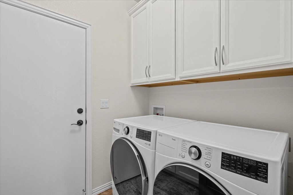 37 Pillow Road Austin, TX 78745 - Photo 16 of 18 Functional laundry room offers a convenient appliance setup and practical cabinetry.