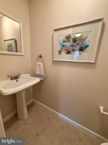 a view of a park with a large trees with wooden fence