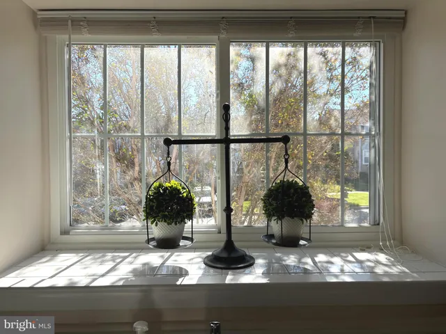 a vase of flowers sitting on a table with wooden floor