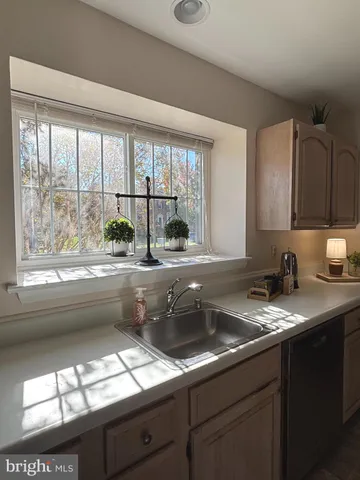 a kitchen with granite countertop a sink and a window