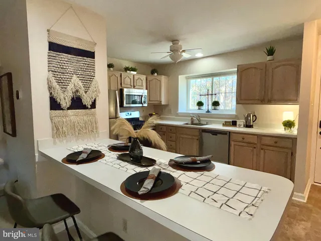 a kitchen with a sink a stove a refrigerator and cabinets