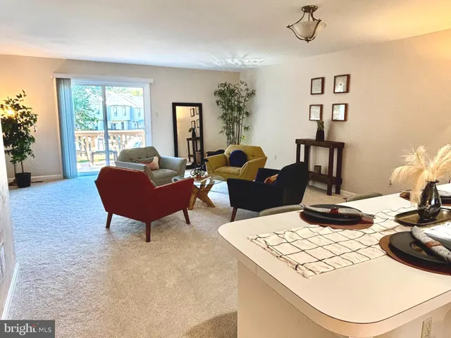 a living room with furniture a table and a large window