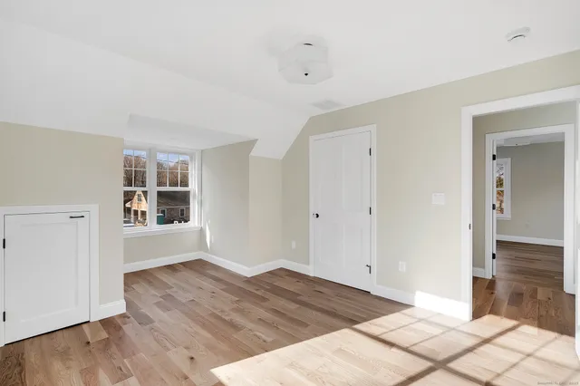 a big room with wooden floor and windows