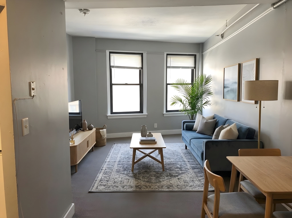 475 Commonwealth Avenue, Unit 306 Boston, MA 02215 - Photo 1 of 11 a living room with furniture and a window