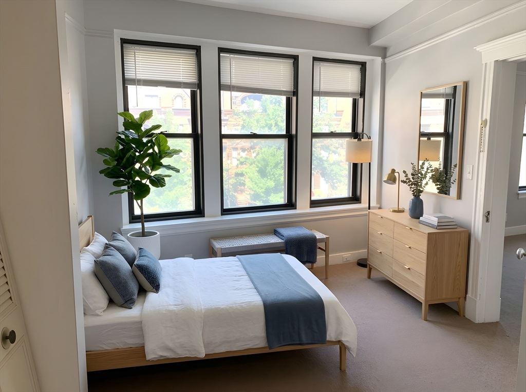 475 Commonwealth Avenue, Unit 306 Boston, MA 02215 - Photo 2 of 11 a bedroom with a bed and a window