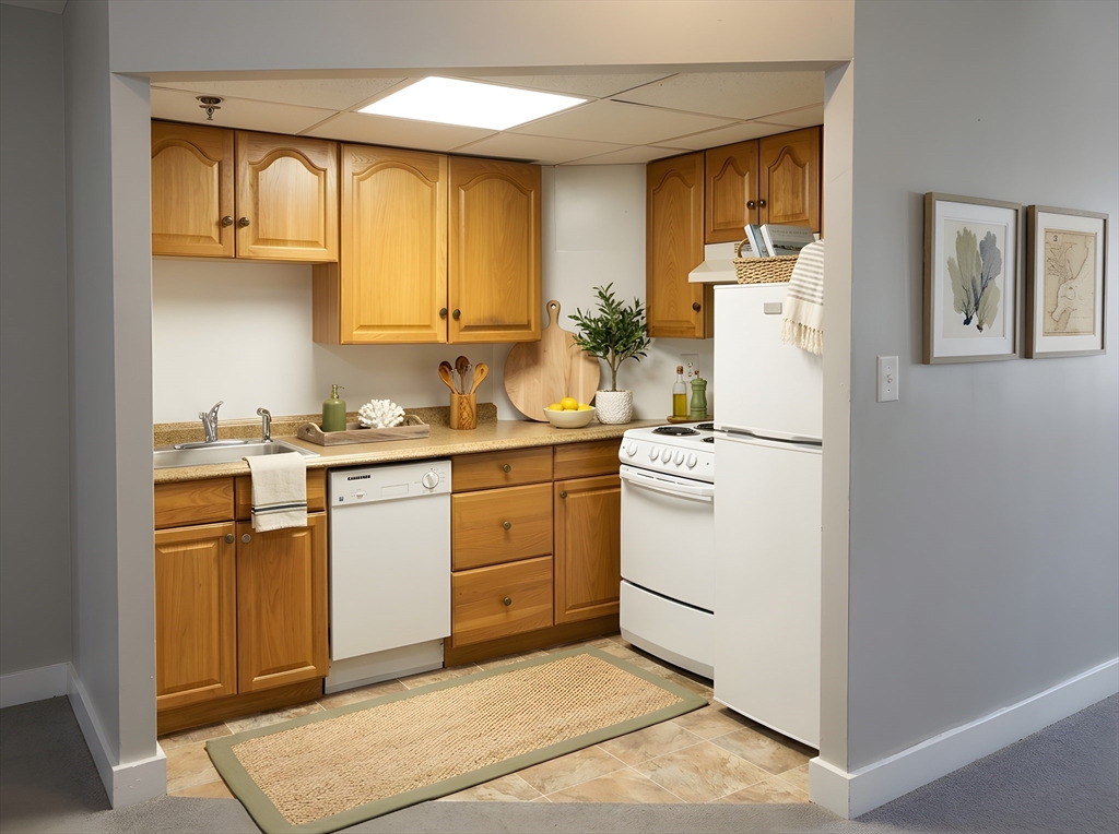 475 Commonwealth Avenue, Unit 306 Boston, MA 02215 - Photo 4 of 11 a utility room with cabinets washer and dryer