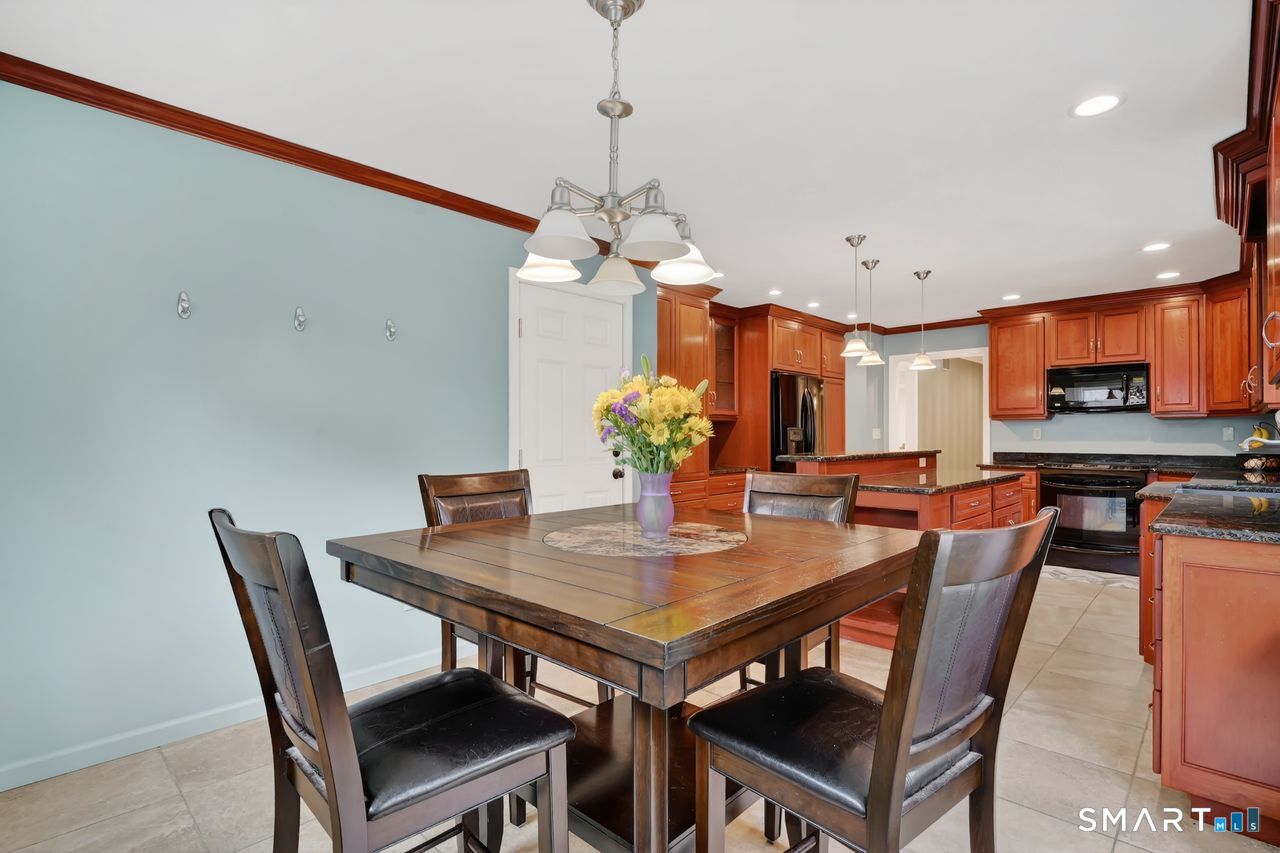 104 Old Farms Road Glastonbury, CT 06073 - Photo 11 of 40 a view of a dining room with furniture and wooden floor