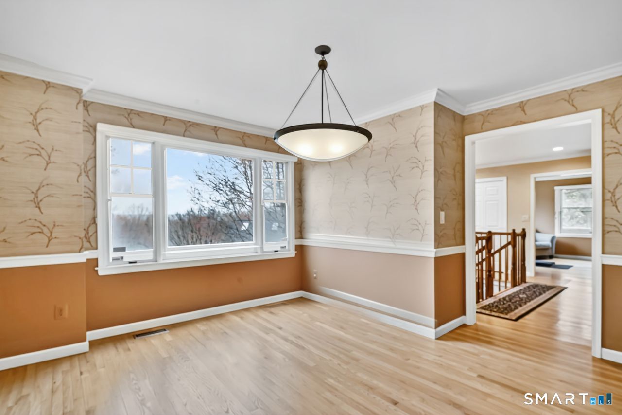 104 Old Farms Road Glastonbury, CT 06073 - Photo 12 of 40 an empty room with wooden floor and windows