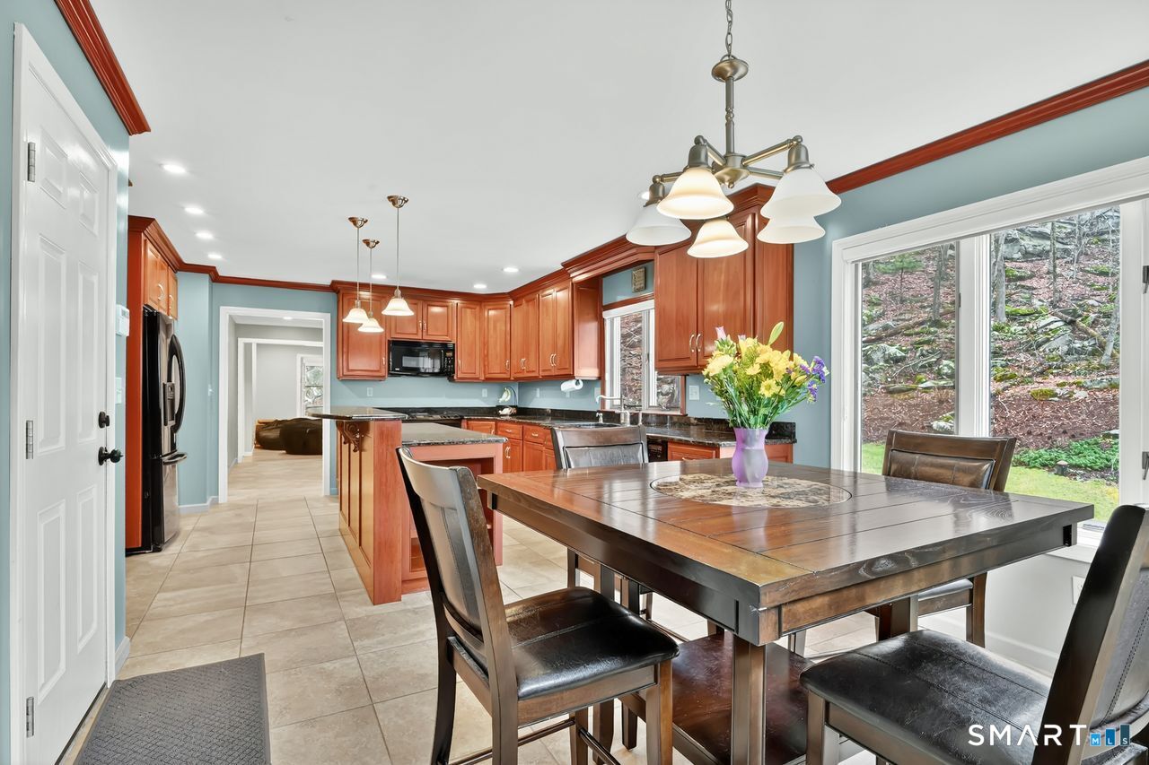 104 Old Farms Road Glastonbury, CT 06073 - Photo 13 of 40 a view of a dining room with furniture window and outside view