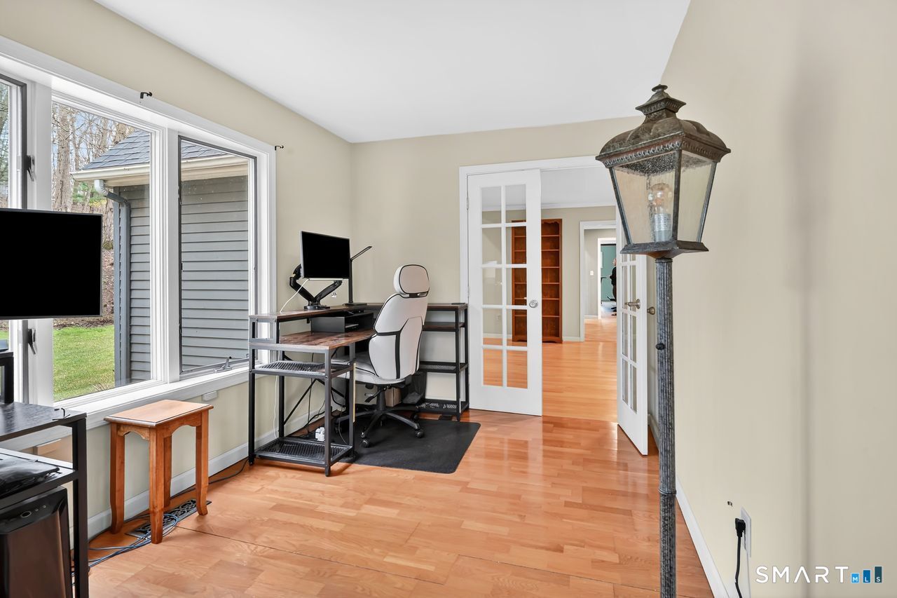 104 Old Farms Road Glastonbury, CT 06073 - Photo 17 of 40 a view of a livingroom with workspace and a window