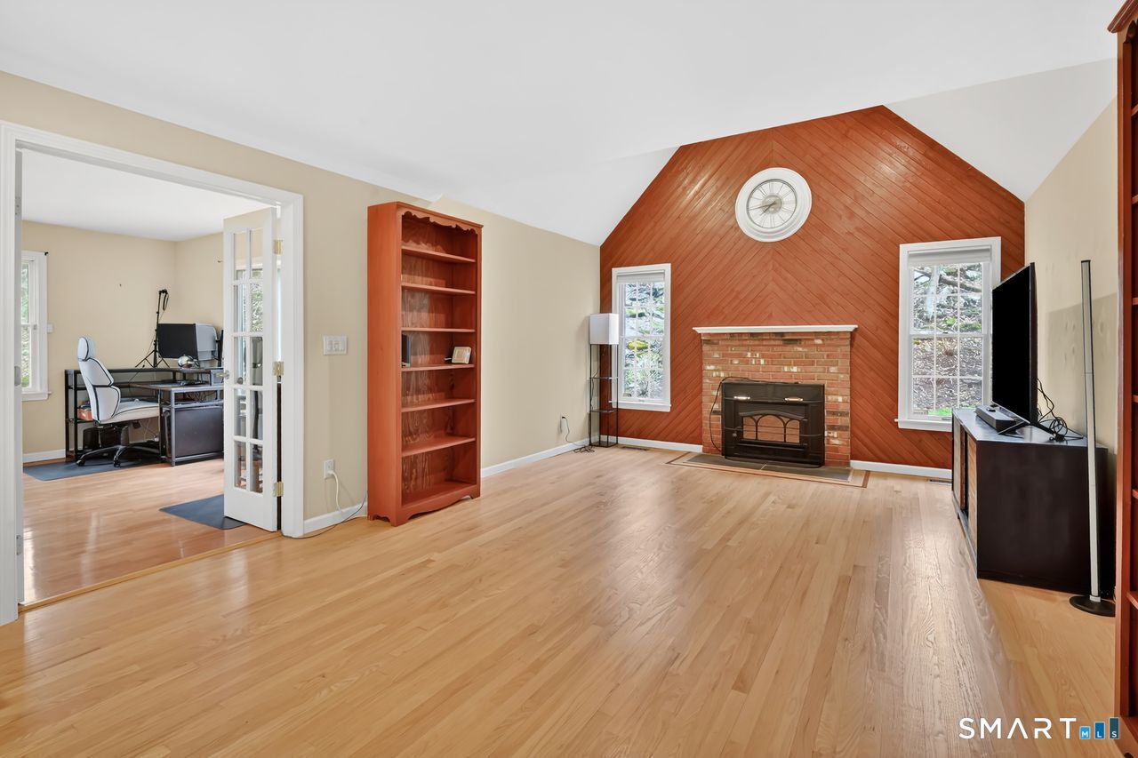 104 Old Farms Road Glastonbury, CT 06073 - Photo 18 of 40 a view of a livingroom with furniture and a fireplace