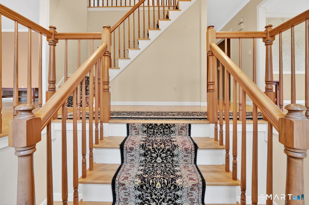 104 Old Farms Road Glastonbury, CT 06073 - Photo 20 of 40 a view of entryway with wooden floor and stairs
