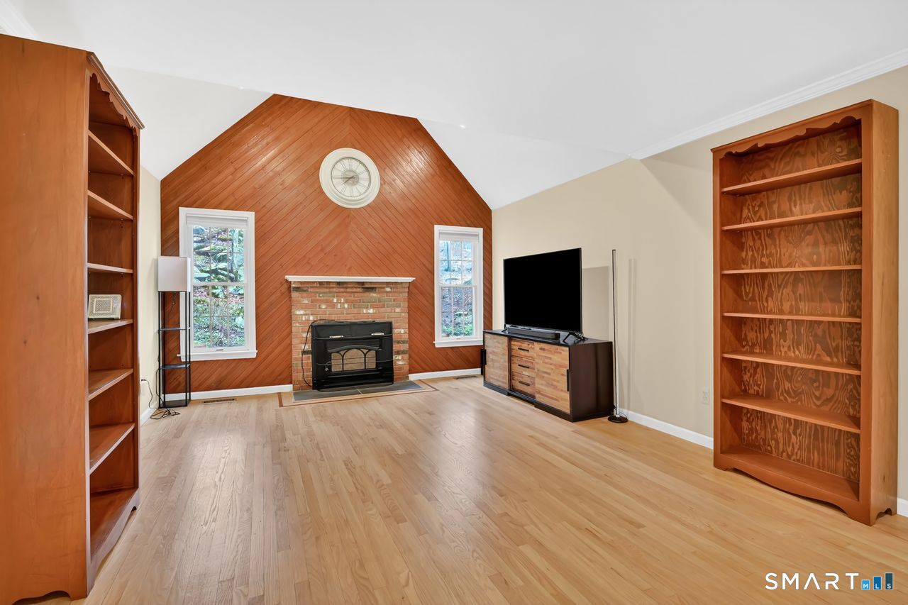 104 Old Farms Road Glastonbury, CT 06073 - Photo 22 of 40 a view of a livingroom with furniture and a fireplace
