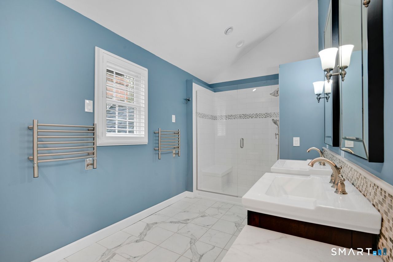 104 Old Farms Road Glastonbury, CT 06073 - Photo 25 of 40 a en suite bathroom with a sink a mirror and a shower