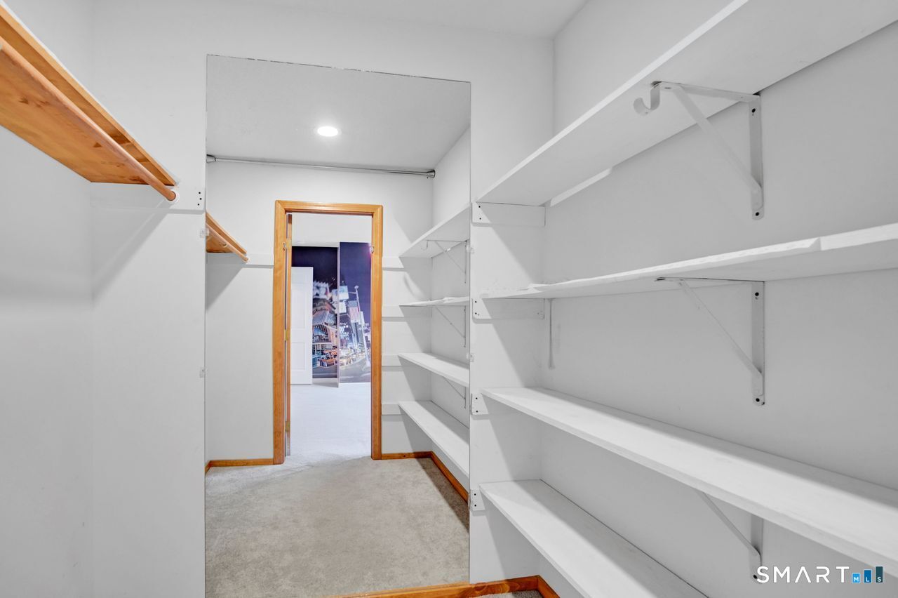 104 Old Farms Road Glastonbury, CT 06073 - Photo 32 of 40 a view of a hallway with white walls and stairs