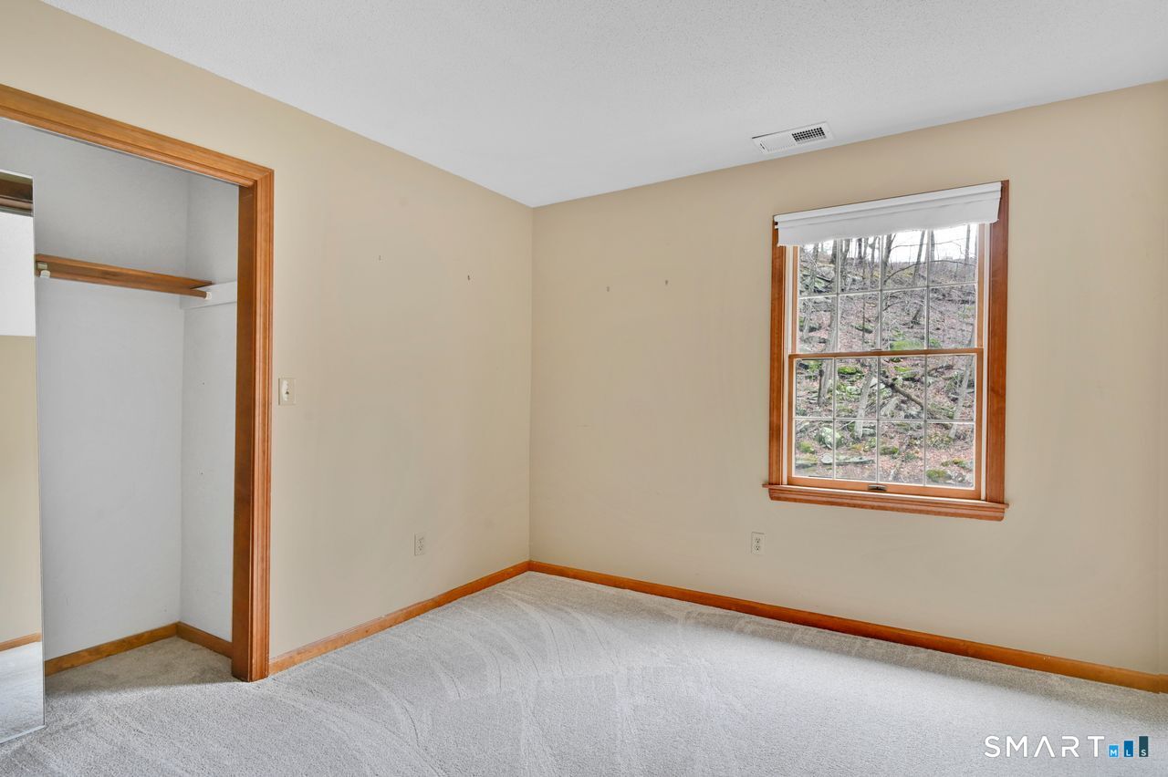104 Old Farms Road Glastonbury, CT 06073 - Photo 33 of 40 a view of an empty room with window and closet