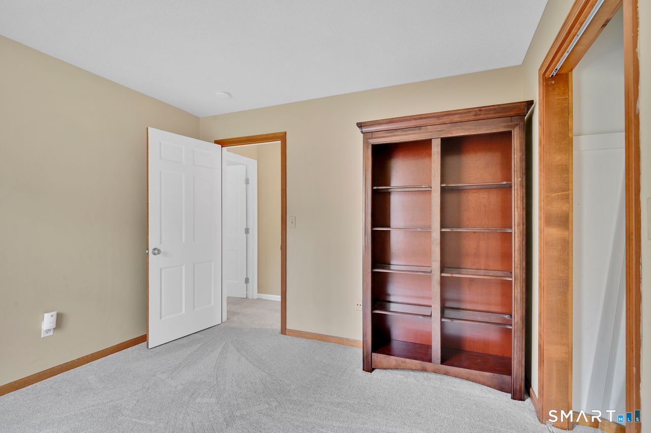 104 Old Farms Road Glastonbury, CT 06073 - Photo 34 of 40 a room with a wooden floor and cabinet