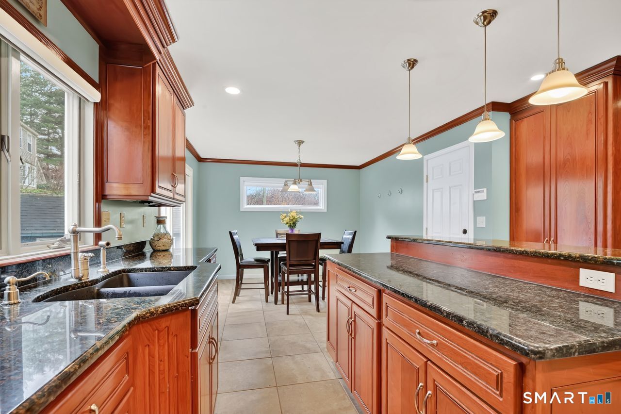 104 Old Farms Road Glastonbury, CT 06073 - Photo 6 of 40 a kitchen with stainless steel appliances granite countertop sink stove and cabinets