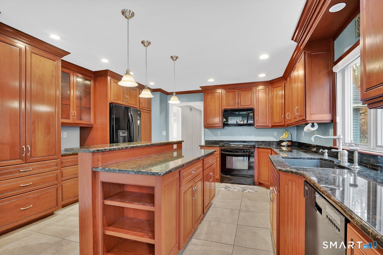104 Old Farms Road Glastonbury, CT 06073 - Photo 8 of 40 a kitchen with stainless steel appliances granite countertop wooden cabinets a stove and a sink