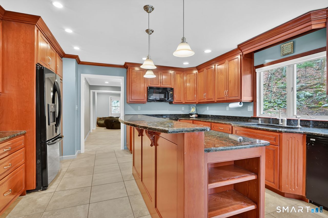 104 Old Farms Road Glastonbury, CT 06073 - Photo 9 of 40 a kitchen with stainless steel appliances granite countertop a refrigerator a sink and a stove