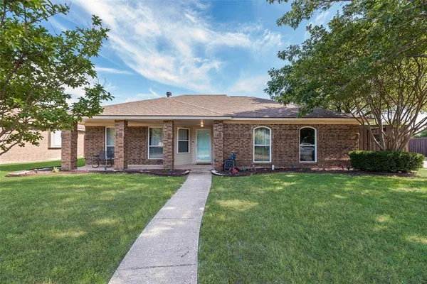 a front view of a house with yard patio and green space