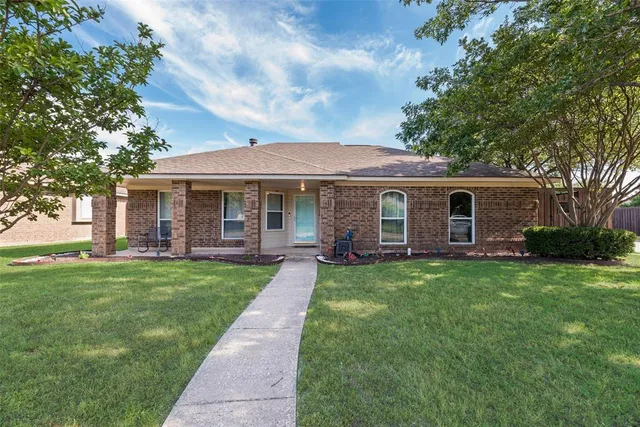 a front view of a house with yard patio and green space