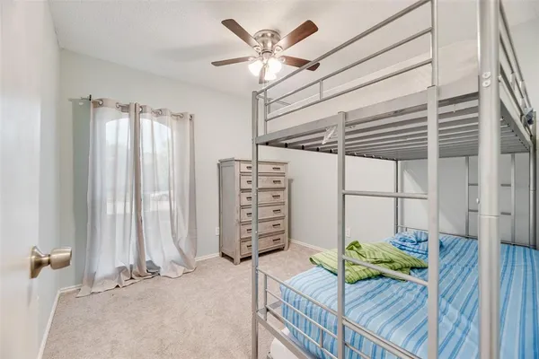 a view of a bedroom with a bed and a chandelier