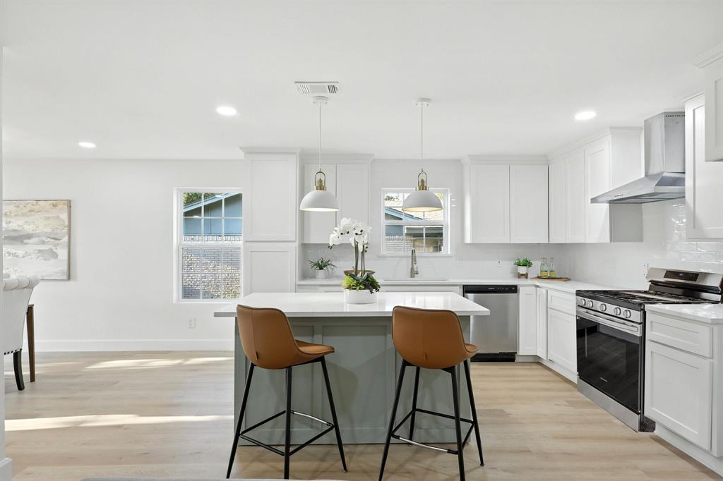 3734 Kimball Ridge Drive Dallas, TX 75233 - Photo 5 of 13 a kitchen with stainless steel appliances a dining table chairs stove refrigerator and cabinets