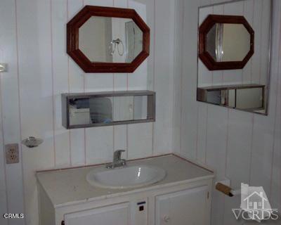 2178 Thrush Avenue, Unit J Oxnard, CA 93033 - Photo 11 of 12 a bathroom with a sink and a mirror