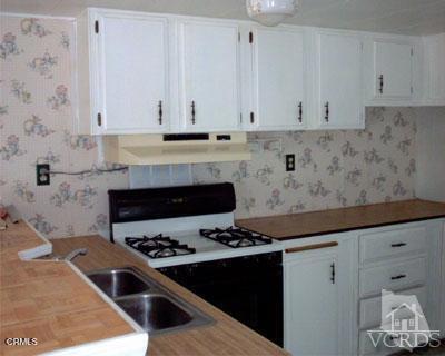 2178 Thrush Avenue, Unit J Oxnard, CA 93033 - Photo 7 of 12 a kitchen with granite countertop a stove and a sink