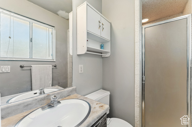 8843 Capernaum Road West Jordan, UT 84088 - Photo 13 of 31 Bathroom with vanity and a shower stall