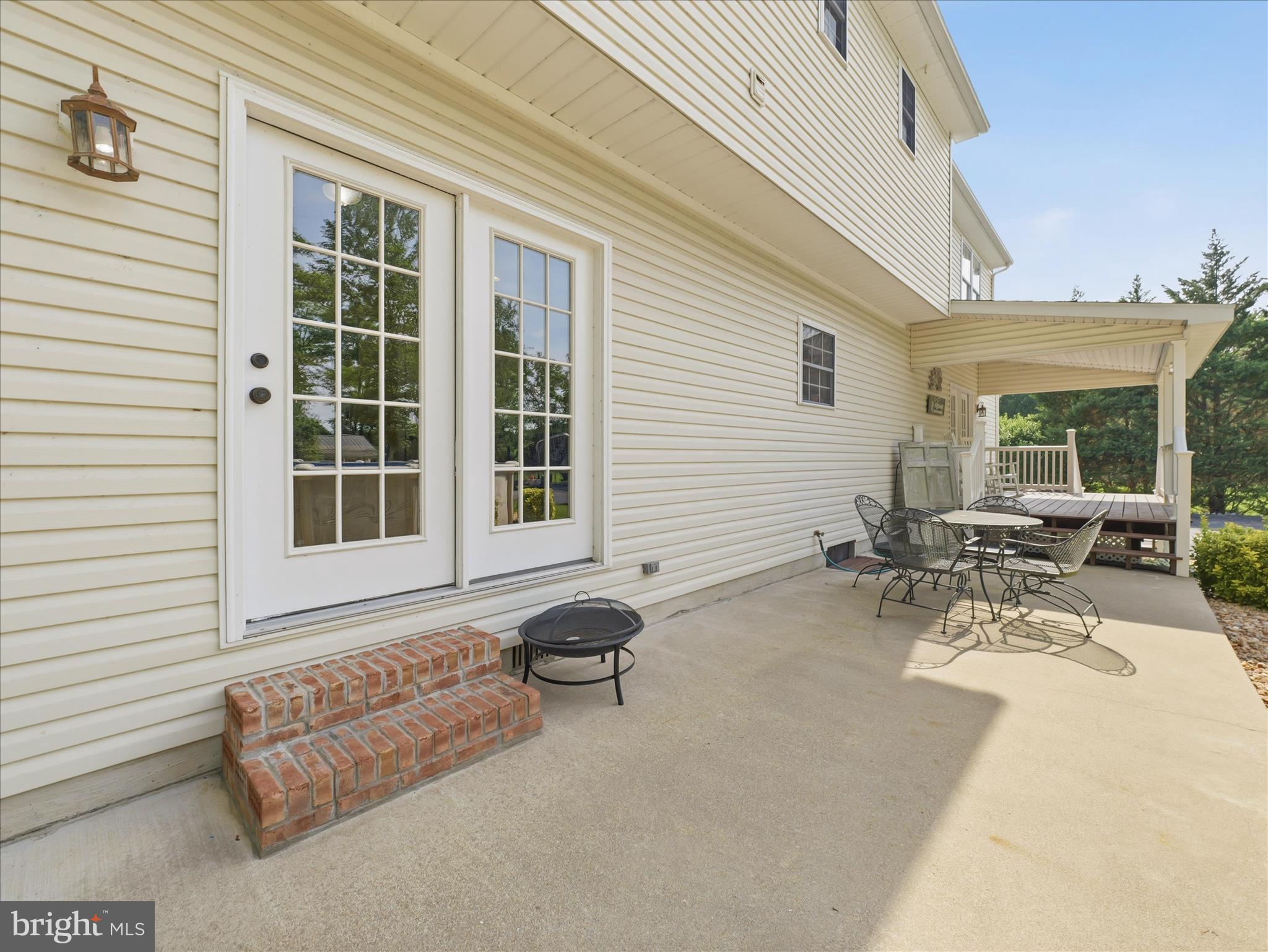 726 Doe Run Road Inwood, WV 25428 - Photo 13 of 68 a view of a patio with table and chairs and potted plants