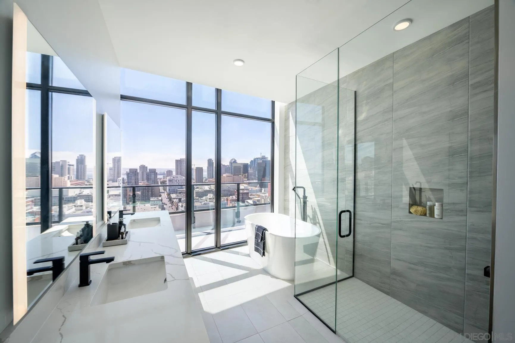 675 Ninth Avenue, Unit 2014 San Diego, CA 92101 - Photo 11 of 12 a spacious bathroom with a glass shower door and a sink
