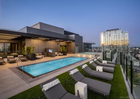 a view of swimming pool with seating area and furniture